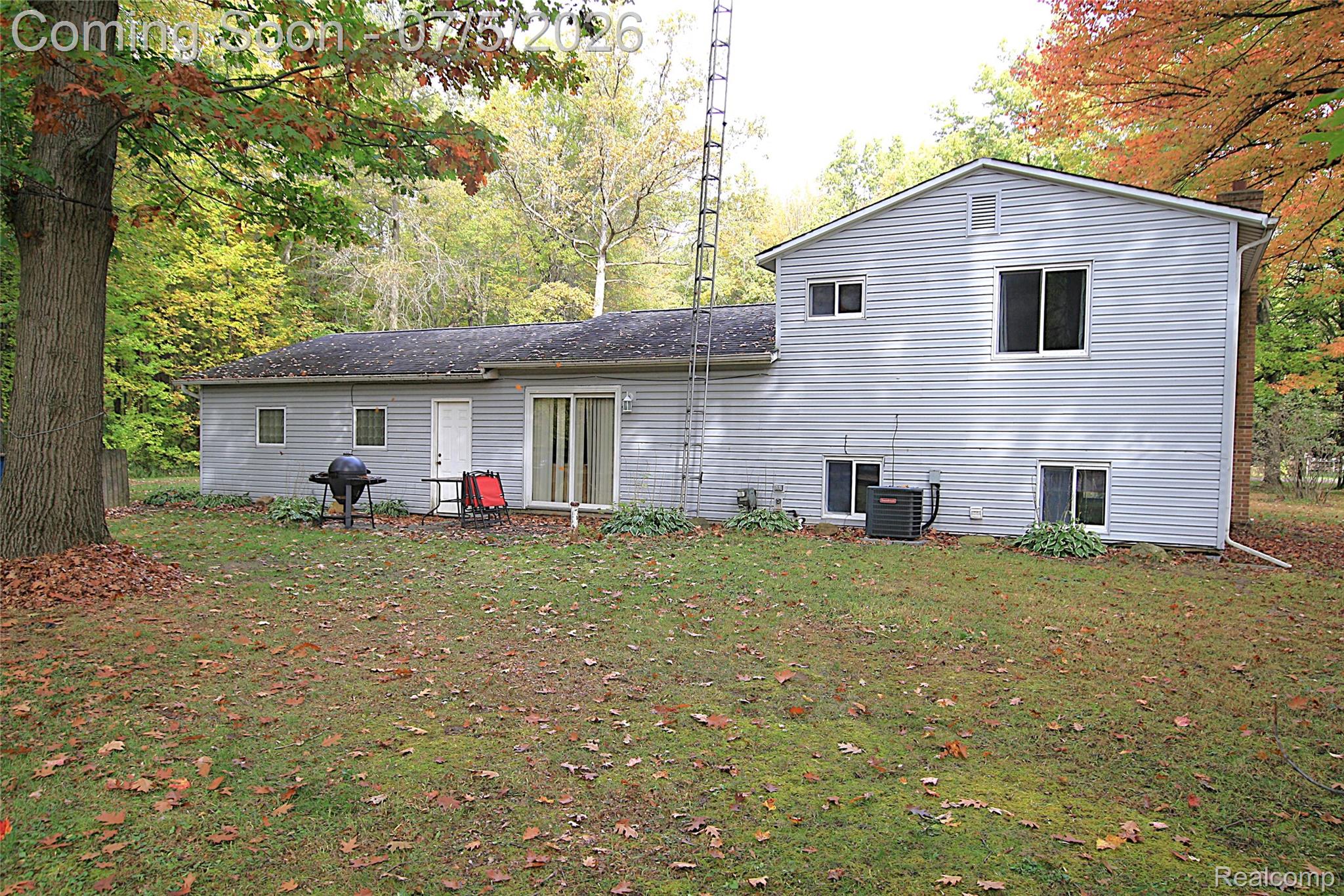 12403 Willard Road Montrose, MI 48457 - Photo 4 of 30 Back of house featuring a lawn