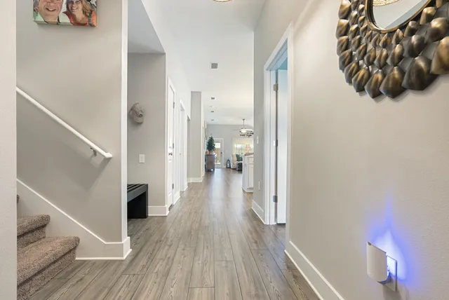 a view of a hallway view with wooden floor and staircase