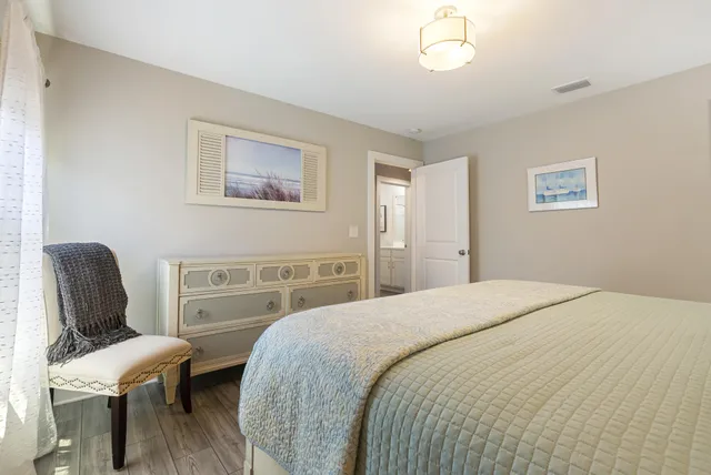 a bedroom with a bed chair and a window