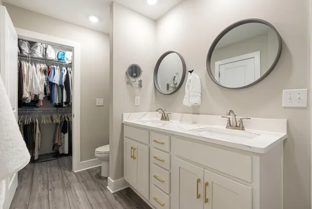 a bathroom with a double vanity sink and a mirror