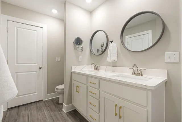 a bathroom with a double vanity sink and a mirror
