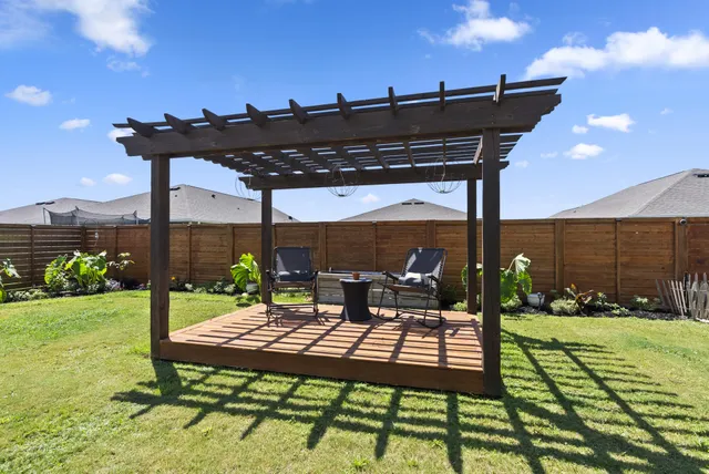 a view of a patio with a table chairs and a swimming pool