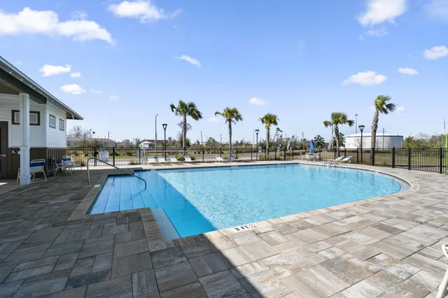 a view of a swimming pool with outdoor seating