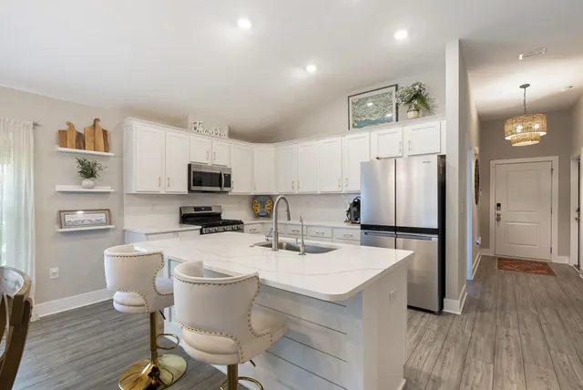 a kitchen with stainless steel appliances a refrigerator and a stove top oven