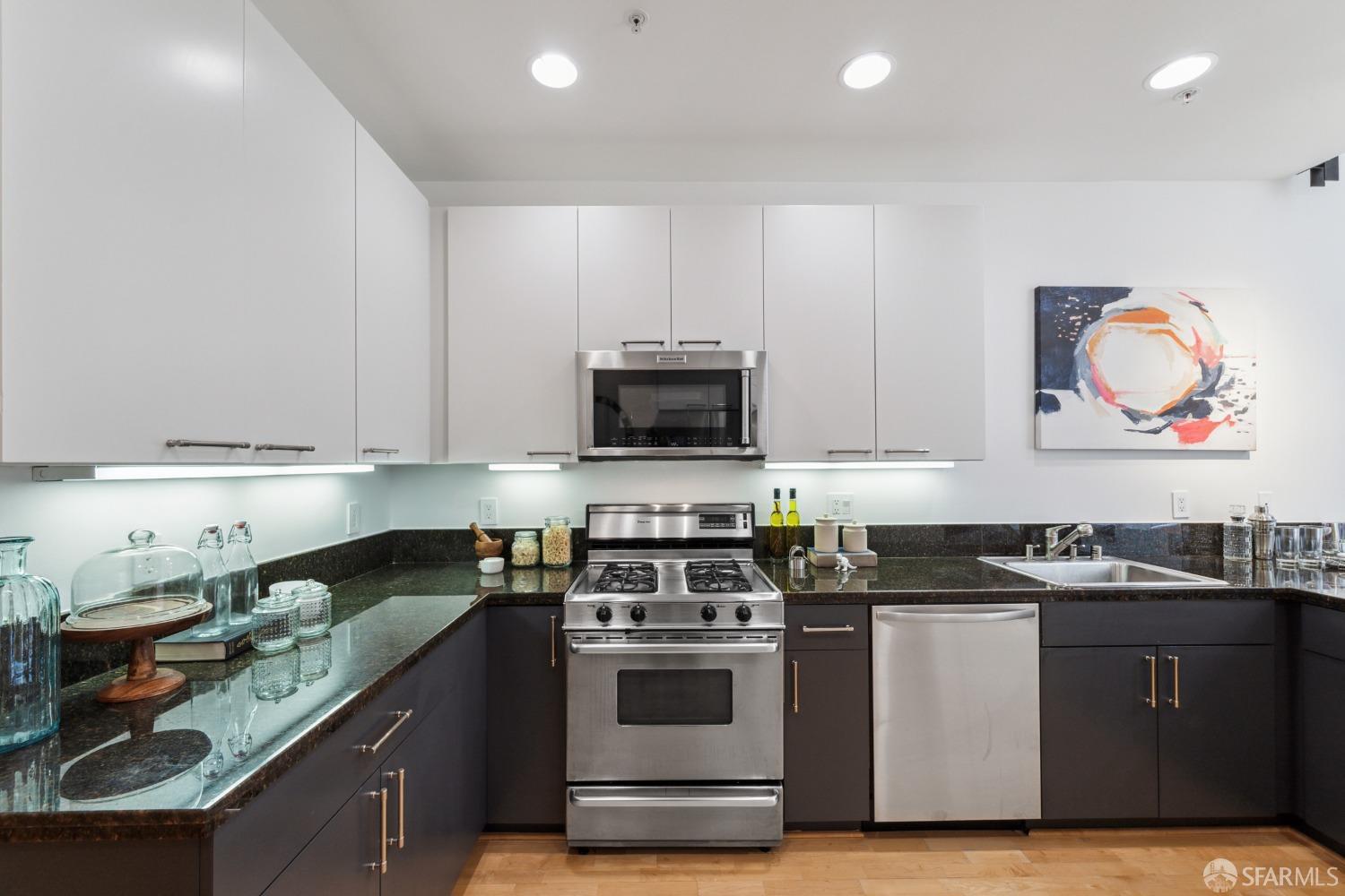 1 Rausch Street, Unit G San Francisco, CA 94103 - Photo 15 of 49 a kitchen with stainless steel appliances granite countertop a stove a sink and a microwave