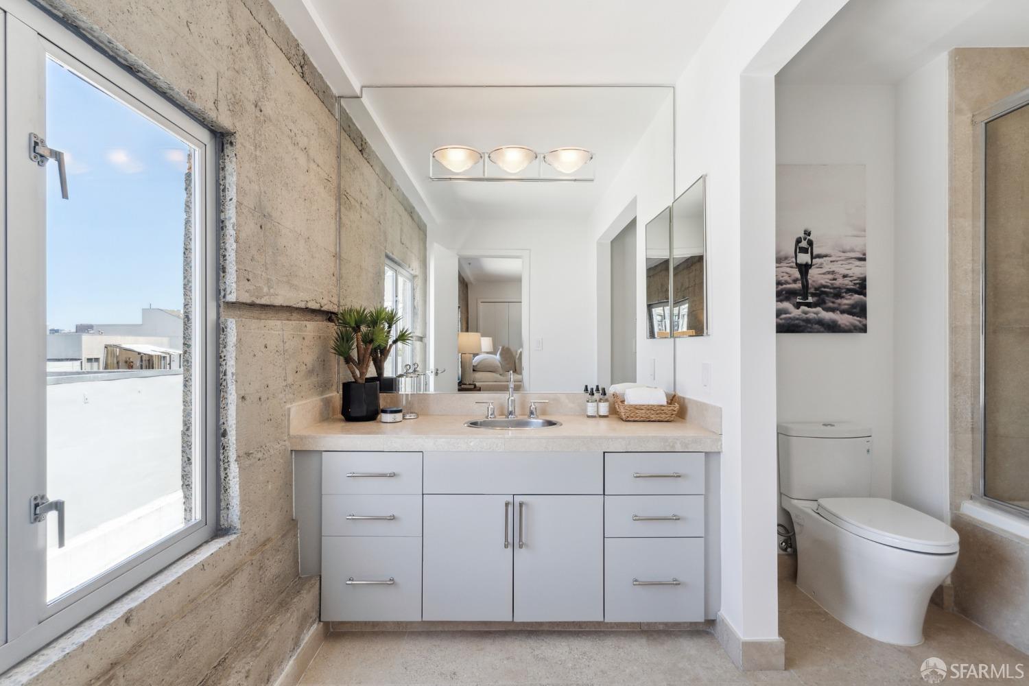 1 Rausch Street, Unit G San Francisco, CA 94103 - Photo 36 of 49 a bathroom with a double vanity sink toilet and shower