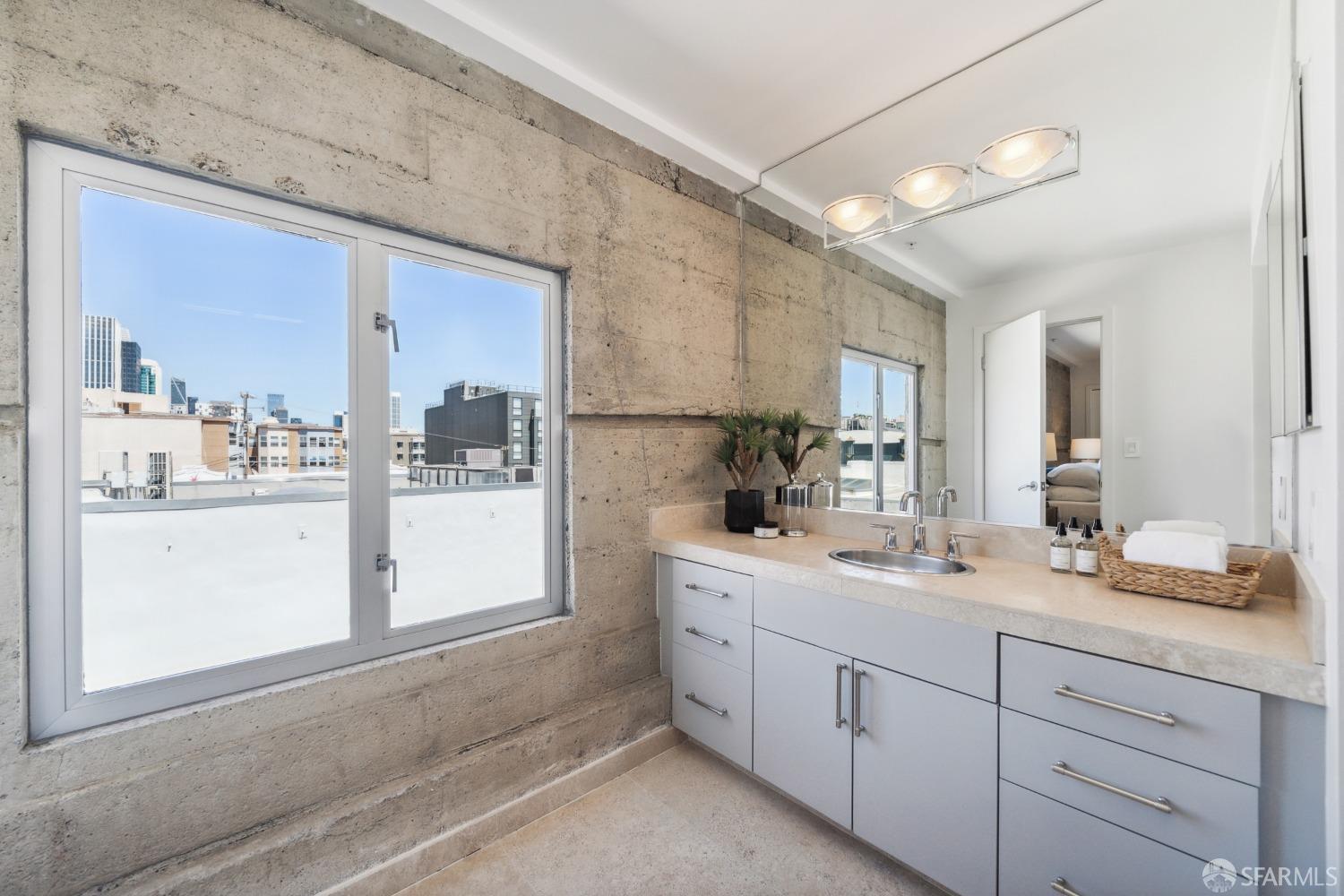 1 Rausch Street, Unit G San Francisco, CA 94103 - Photo 37 of 49 a bathroom with a sink a mirror and next to a window