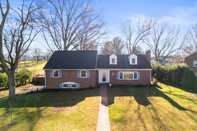 a view of a house with backyard and lake view