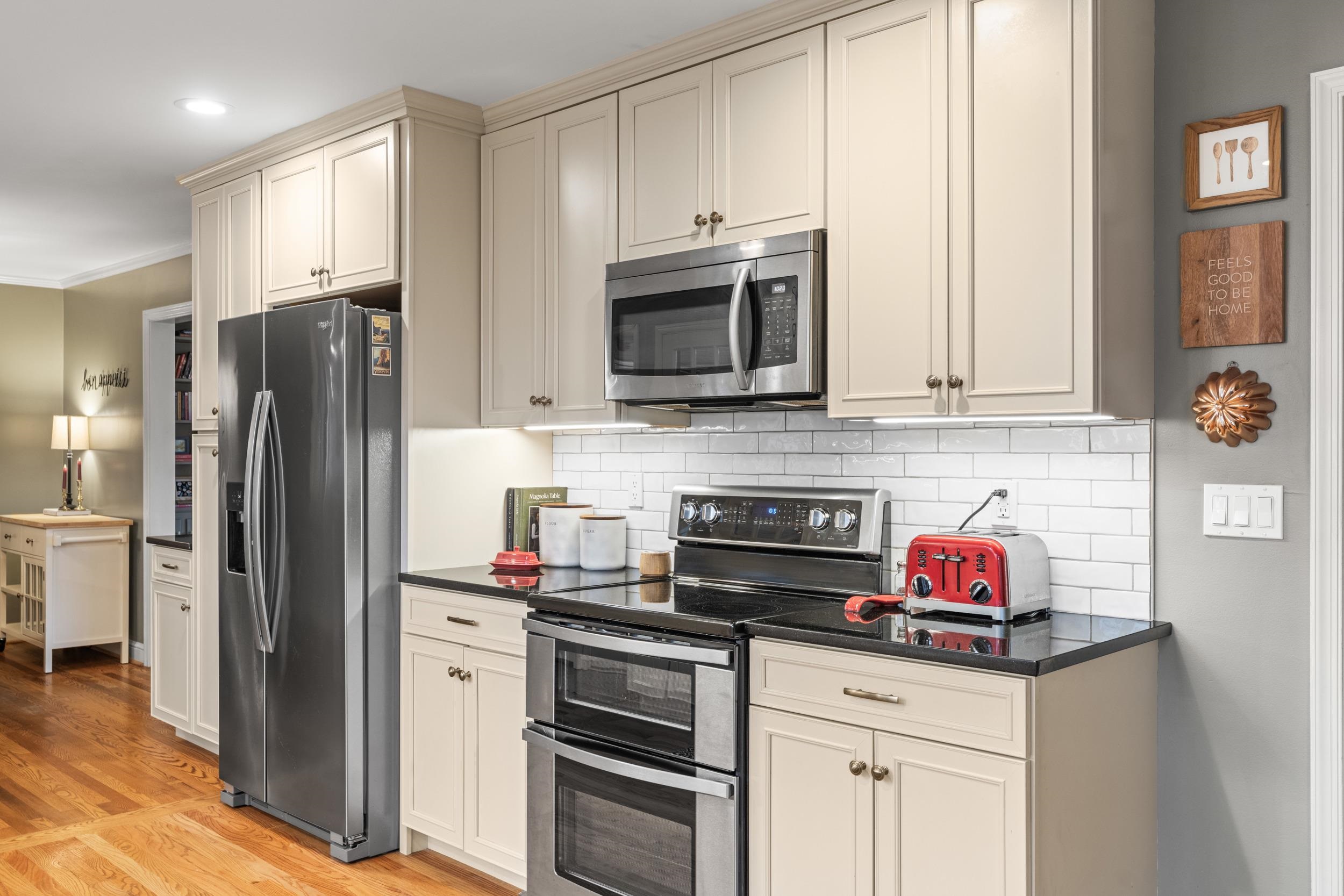 1220 Chatham Road Waynesboro, VA 22980 - Photo 14 of 64 a kitchen with granite countertop a refrigerator stove and microwave