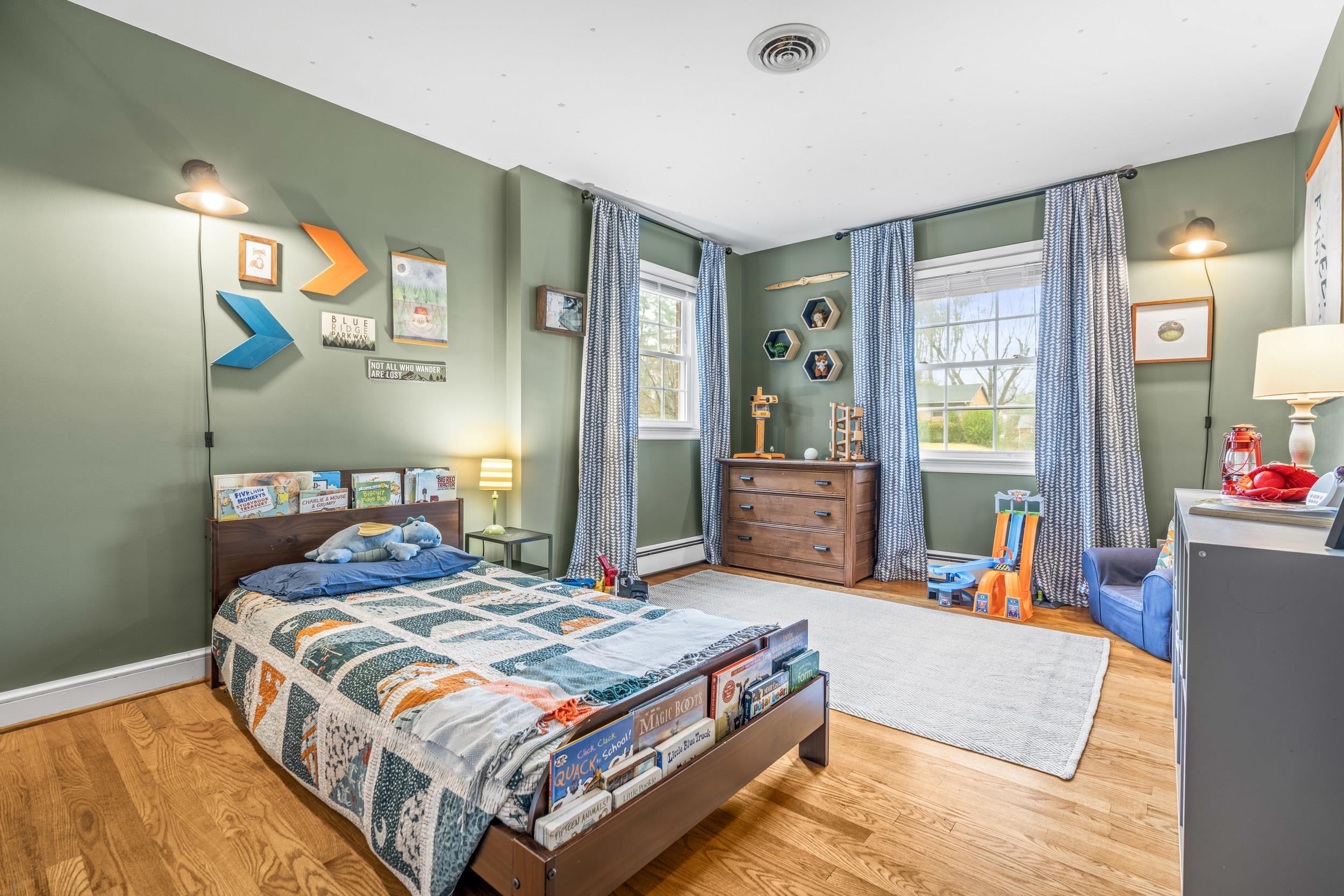 1220 Chatham Road Waynesboro, VA 22980 - Photo 44 of 64 a bedroom with a bed and dresser with mirror