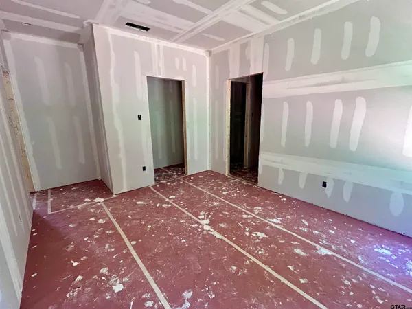 a bedroom with a bed and a mirror