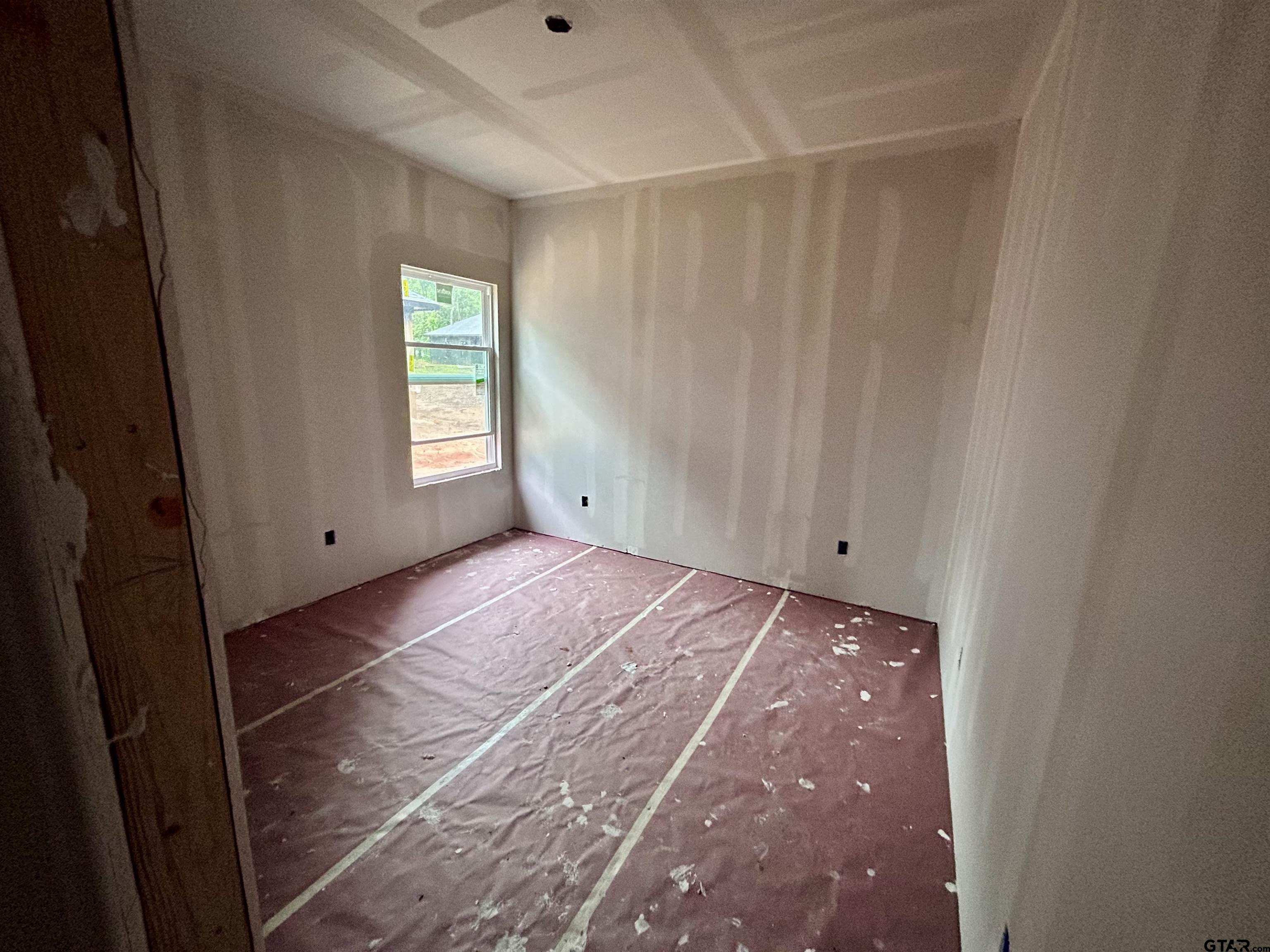 203 East Fleming Street Longview, TX 75604 - Photo 8 of 12 a view of an empty room with a window