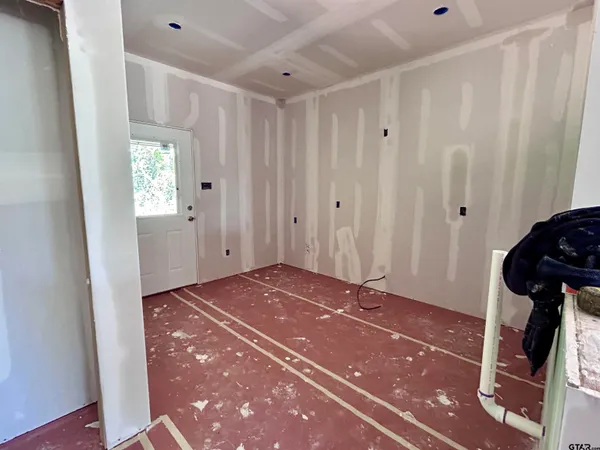 an empty room with windows and closet
