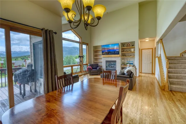 a living room with fireplace furniture and a large window