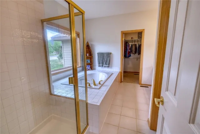 a bathroom with a tub and shower