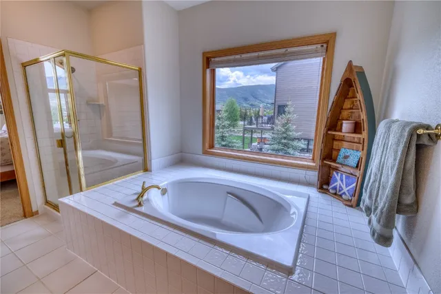 a bathroom with a tub and a window