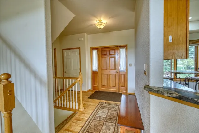 a view of a hallway to a livingroom with furniture