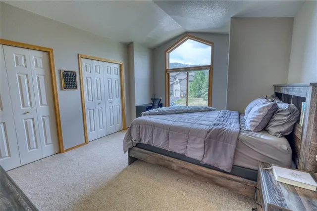 a bed sitting in a bedroom next to a window