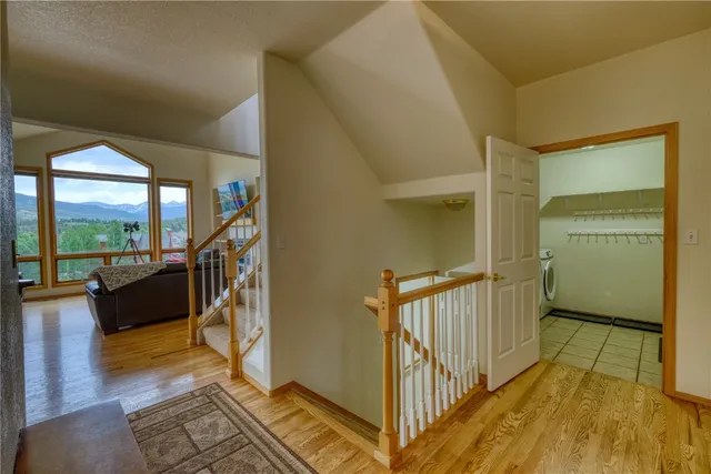 a view of a hallway with wooden floor and in living room