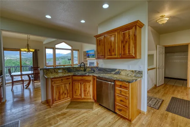 a kitchen with stainless steel appliances granite countertop a stove and a sink