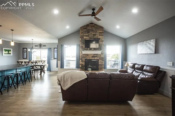 a living room with fireplace furniture and a wooden floor