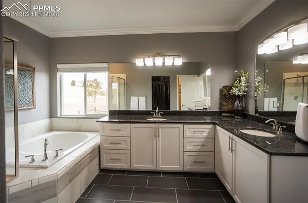 a large white kitchen with a sink and dishwasher a stove with wooden floor