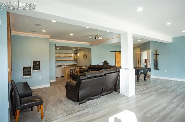 a living room with furniture and a wooden floor