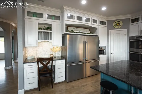 a kitchen with stainless steel appliances granite countertop a refrigerator and a stove