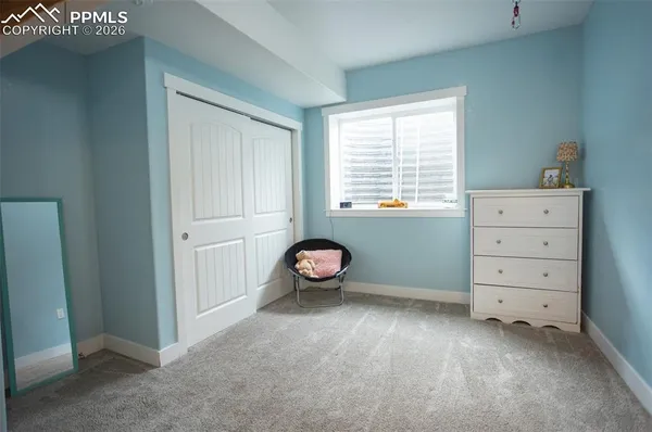 a view of a livingroom with baby crib