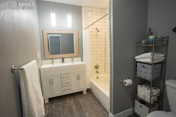 a bathroom with a sink a mirror and a toilet
