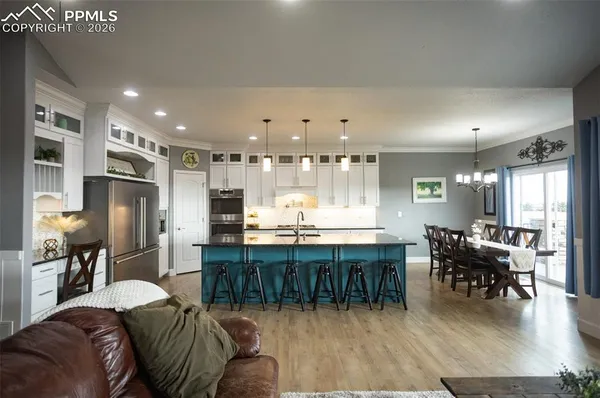 a large kitchen with a table and chairs