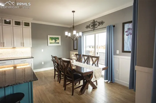 a view of a dining room with furniture window and wooden floor