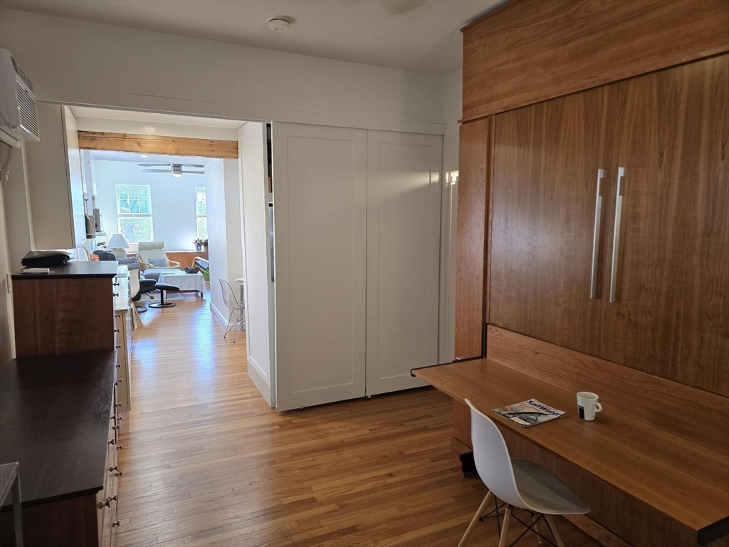 274 Main Street, Unit 5 Gloucester, MA 01930 - Photo 16 of 17 an empty room with wooden floor and windows