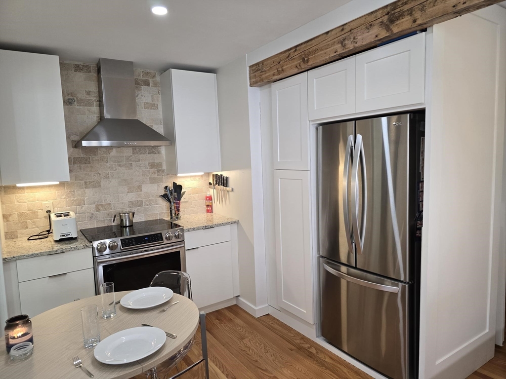274 Main Street, Unit 5 Gloucester, MA 01930 - Photo 2 of 17 a kitchen with a sink stainless steel appliances and cabinets