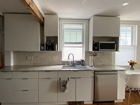 274 Main Street, Unit 5 Gloucester, MA 01930 - Photo 4 of 17 a kitchen with stainless steel appliances granite countertop a sink and a microwave
