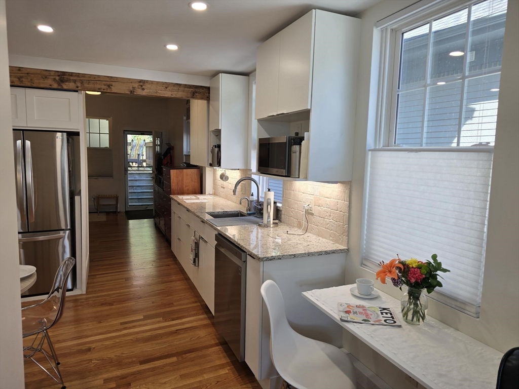 274 Main Street, Unit 5 Gloucester, MA 01930 - Photo 5 of 17 a dining hall with stainless steel appliances granite countertop a stove and a refrigerator