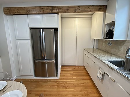 274 Main Street, Unit 5 Gloucester, MA 01930 - Photo 6 of 17 a view of a kitchen with wooden floor and staircase