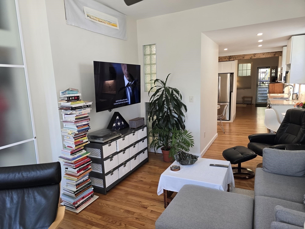 274 Main Street, Unit 5 Gloucester, MA 01930 - Photo 8 of 17 a living room with furniture and a flat screen tv