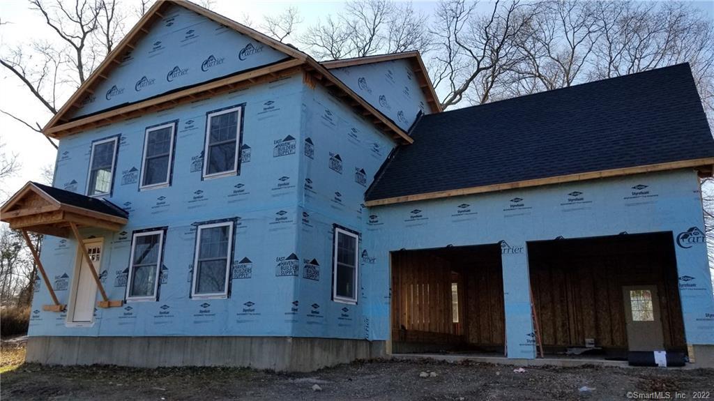 a view of a house with a door and wooden wall