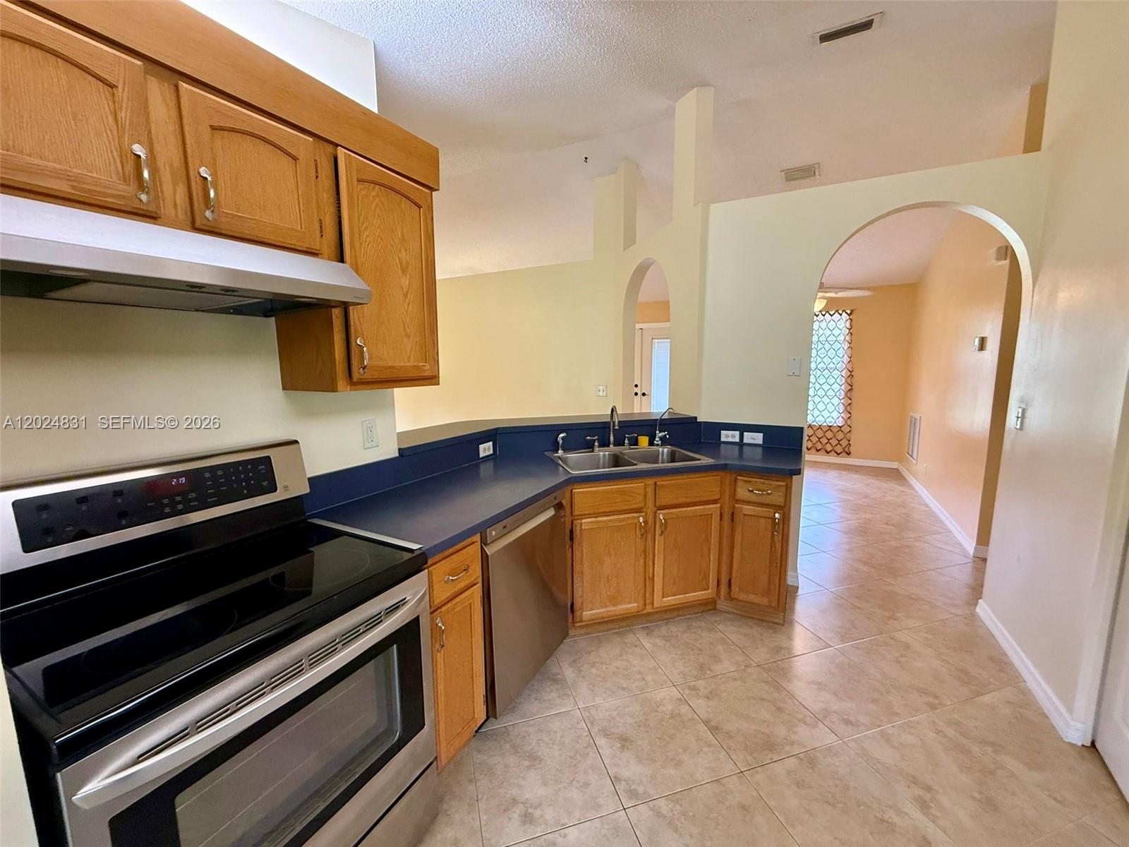 15819 76th Road North Loxahatchee, FL 33470 - Photo 18 of 45 a kitchen with stainless steel appliances granite countertop a stove and a sink