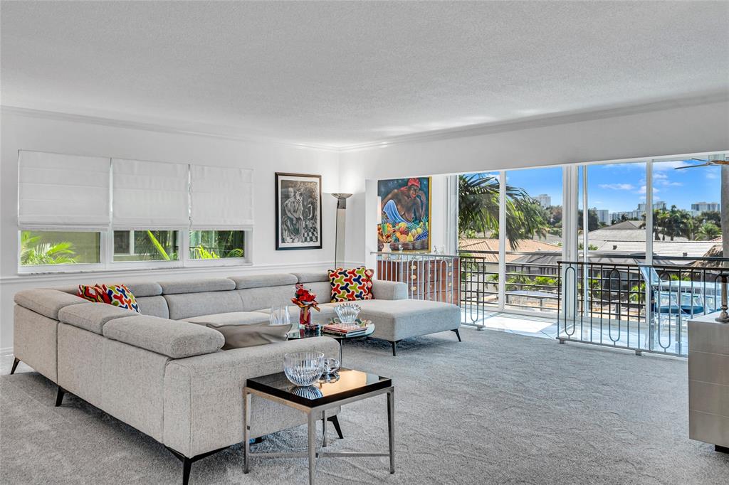 a living room with furniture and a floor to ceiling window