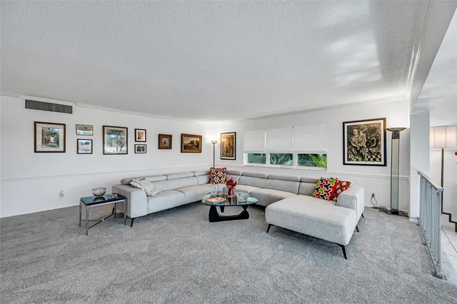 a living room with furniture and white walls