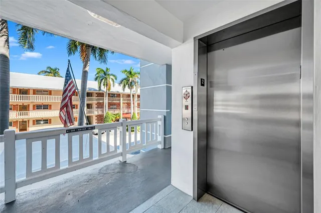 a front view of a building with glass windows and ceiling fan