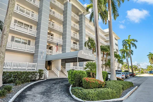 a living room with furniture a flat screen tv and a large window