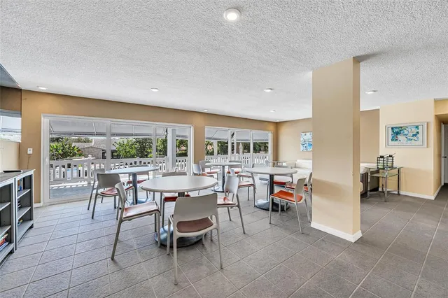a roof deck with table and chairs