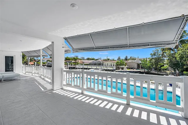 a swimming pool with outdoor seating and yard