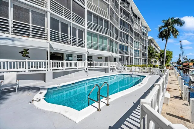 a view of a house with swimming pool outdoor seating