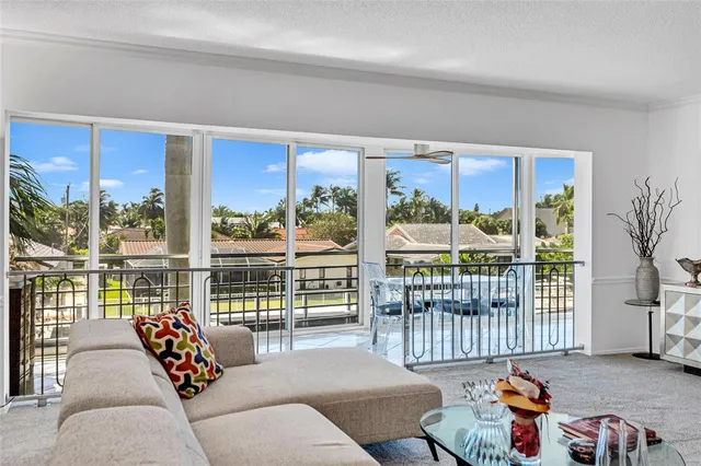 a living room with furniture and a floor to ceiling window