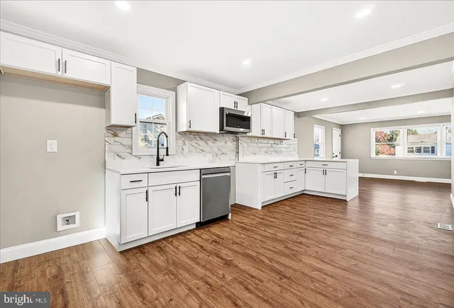 a kitchen with wooden floors and white appliances