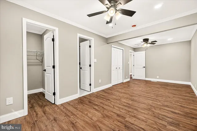 a view of a room with a ceiling fan